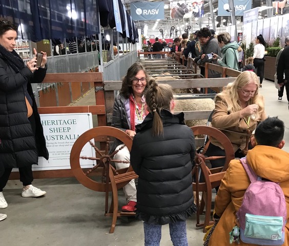 Susan Campbell-Wright with good friend and ACC steward, Stacey Robinson, demonstrating spinning wool in the livestock pavilion.
